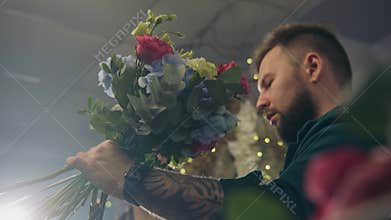Two florists look on beautiful arrangement