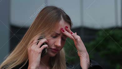 Head shot close up displeased young woman looking at smartphone screen outdoors, dissatisfied with bad news message