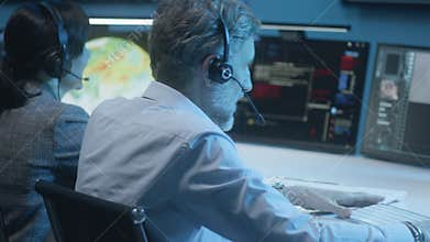 Flight control workers monitor successful space rocket launch