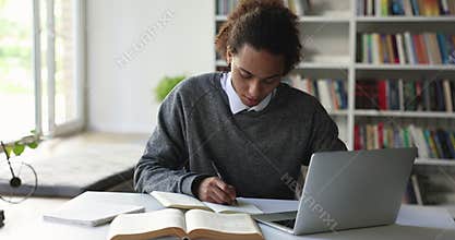 Student guy doing exercise, prepare essay, makes assignment using laptop