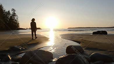 Adventurous Woman Standing on the Sandy Beach on the West Coast of Pacific Ocean.