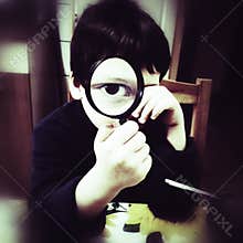 Curious boy with magnifier