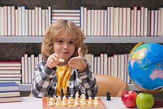 Play chess. Chess for intelligent kid. Child genius, smart pupil playing logic board game. Clever school boy thinking