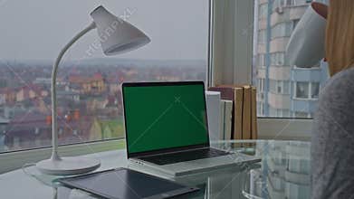 Woman drinks tea at workplace