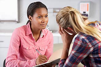 Teenage Girl Visits Doctor's Office Suffering With Depression