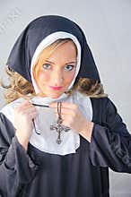 Nun putting on Christian cross
