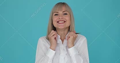 Woman Expressing Amazement and Exclaiming Wow to the Camera on Blue Background