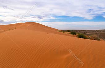 Lone figure on the top of the famous Big Red sand dune