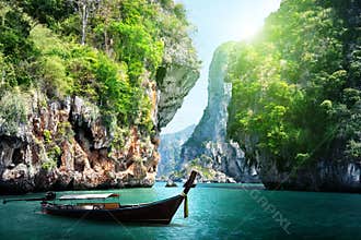 Long boat and rocks on railay beach in Thailand