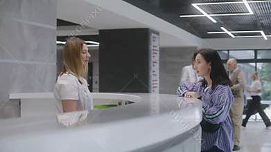 Woman makes appointment with doctor in lobby