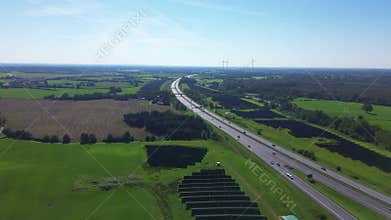 Aerial view on the A7 motorway in northern Germany between fields and meadows