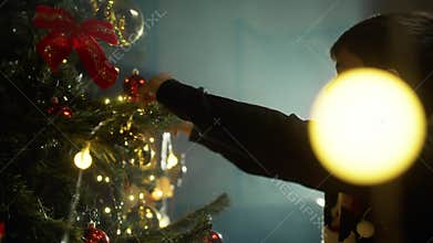 Kid Lighting a Christmas tree for holidays