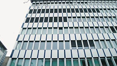 Glass Exterior of a Contemporary Skyscraper, Revealing Dynamic Interplay of Architecture in Heart of Corporate City