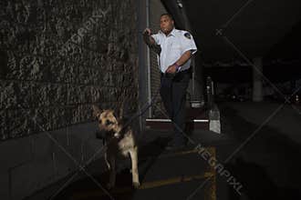 Security Guard In Alleyway Pursuit With Dog