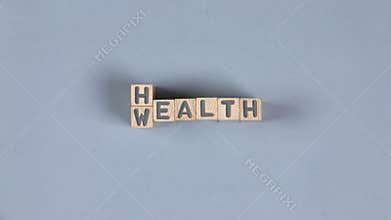 Wooden blocks with wealth and health sign.