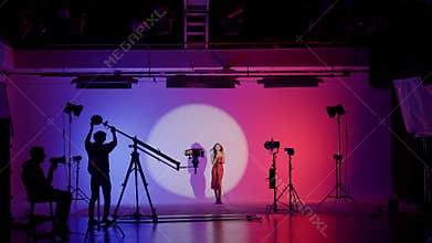 Professional filming pavilion with a neon cyclorama. The process of preparing for the shooting of a music video