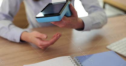 Female banker gives client portable terminal to pay