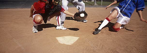 Players Playing Baseball On Field
