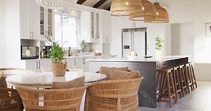 Close up of house interior with plants on tables and chairs