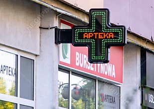 Cross logo APTEKA Pharmacy in English at storefront in Poland