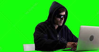 Hacker using laptop with green screen