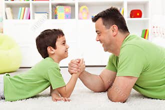 Father and son arm wrestling