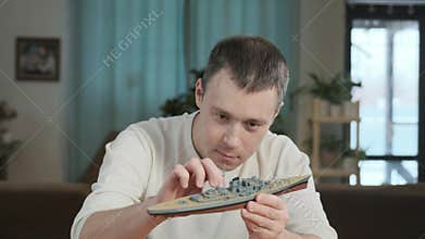 Man assemble plastic model. Passion for modeling and building toys