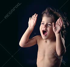 Cute kid with surprised expression acting funny