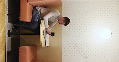 Young freelancer guy sitting in separate workplace booth