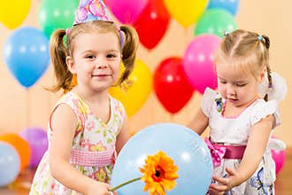 Happy children girls with gifts on birthday party