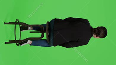 Vertical video: Back view of company employee sitting on chair and waiting