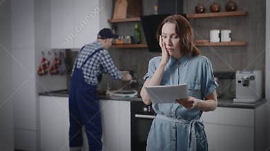 A housewife is shocked by the price of a kitchen renovation service. The worker charged a very expensive bill for his