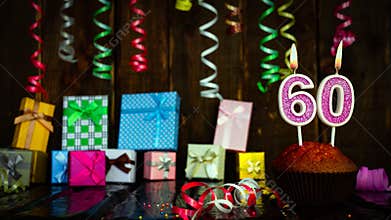 Party birthday background with number 60. Beautiful background anniversary copy space with burning candles. Gift boxes