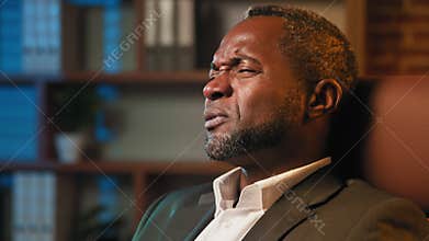 Serious african american man discussing business issues with client or partner on video call mature teacher hold online