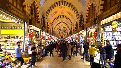 People walk in one of the corridors of the Misir Carsisi market.
