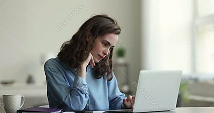Young blogger woman, author writing article, sitting at desk