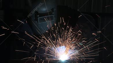 Industrial workers at steel structure welding plant A welder is welding metal parts in a small workshop.vdo 4k