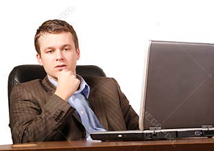 Thinking business man with laptop - smart casual