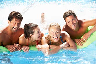 Group Of Friends Having Fun In Swimming Pool