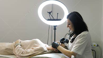 Beauty injections. Lip augmentation procedure. Lip injection plastic surgery. The cosmetologist in medical gloves