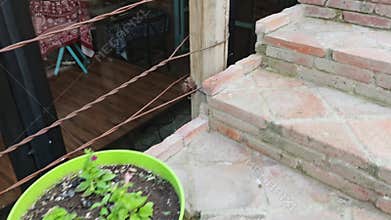 Colorful flower pots decorating brick stairs of a restaurant
