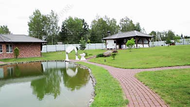 agro-estate territory with landscape design, lake and gazebo. Beautiful nature in summer, copy space for text