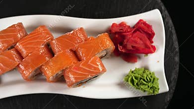 On a plate, a set of sushi rolls rotate.