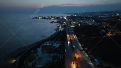 Stunning aerial sunset to night transition over Turkler in Alanya, Turkey. Alanya coastline,resorts,marina,hotels and city lights