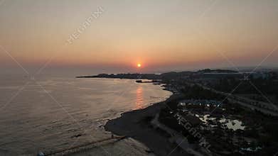 Stunning aerial sunset to night transition over Turkler in Alanya, Turkey. Alanya coastline,resorts,marina,hotels and city lights
