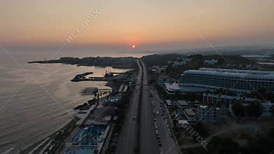 Stunning aerial sunset to night transition over Turkler in Alanya, Turkey. Alanya coastline,resorts,marina,hotels and city lights