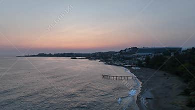 Stunning aerial sunset to night transition over Turkler in Alanya, Turkey. Alanya coastline,resorts,marina,hotels and city lights