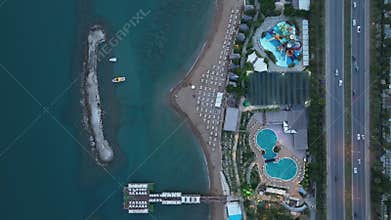 Stunning aerial sunset to night transition over Turkler in Alanya, Turkey. Alanya coastline,resorts,marina,hotels and city lights