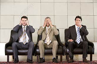 Three businessmen showing
