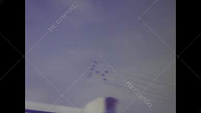 Vintage footage of red arrows flying near a concorde